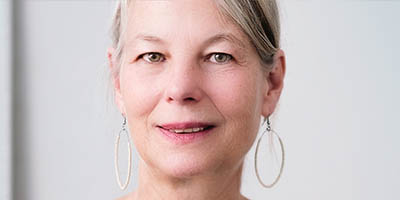 Woman with round earrings looking directly into the camera
